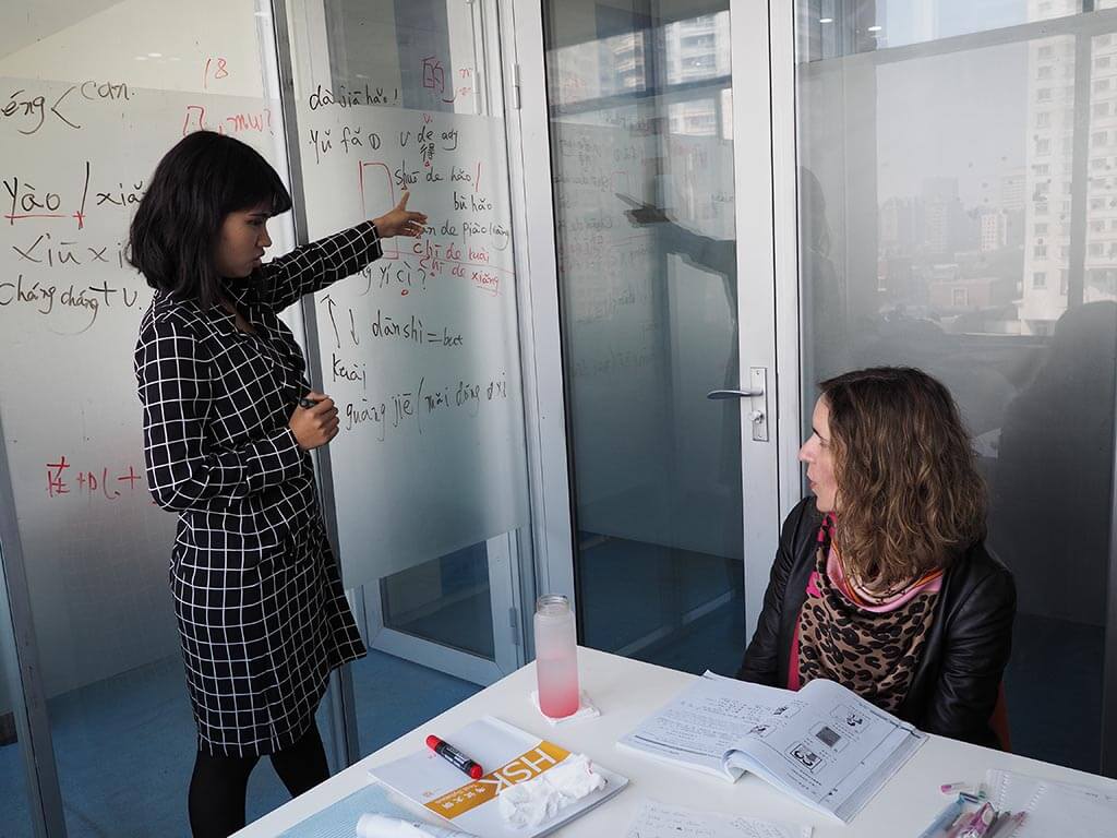 Teacher and student in classroom during Chinese class