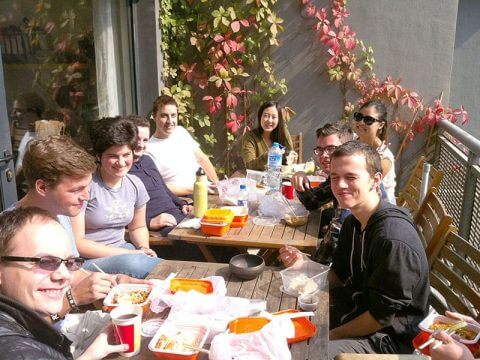 Students and staff having lunch together in the sun on the LTL Beijing balcony 