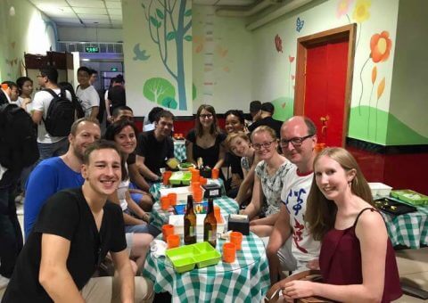 Group of LTL students and staff waiting for a table at Hai Di Lao hot pot in Beijing