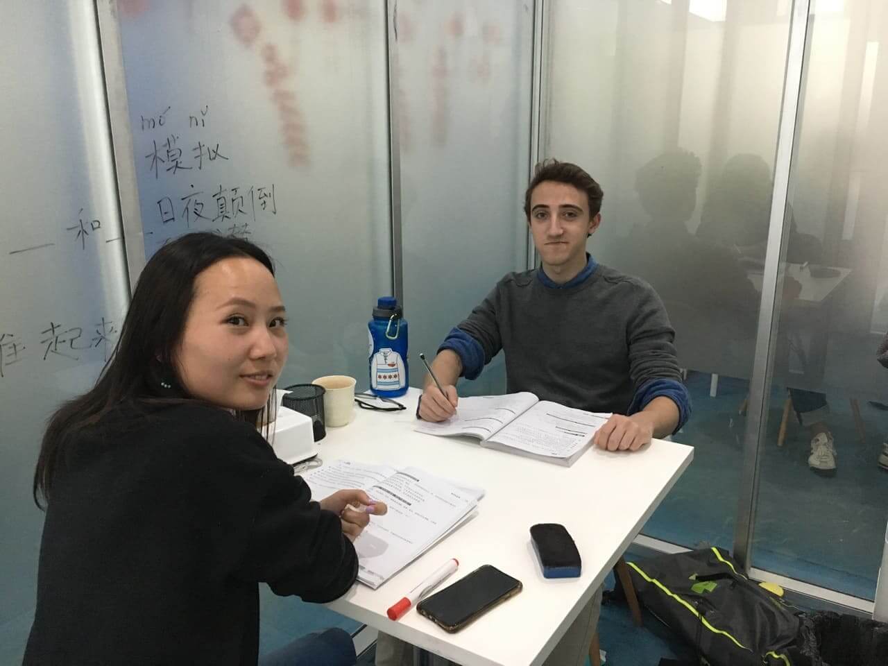 Teacher and student sitting in classroom having individual Chinese class