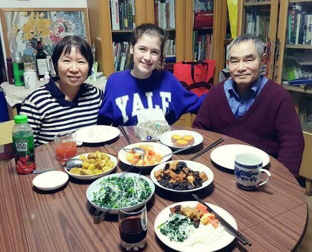 Savannah eating dinner with her Homestay Family