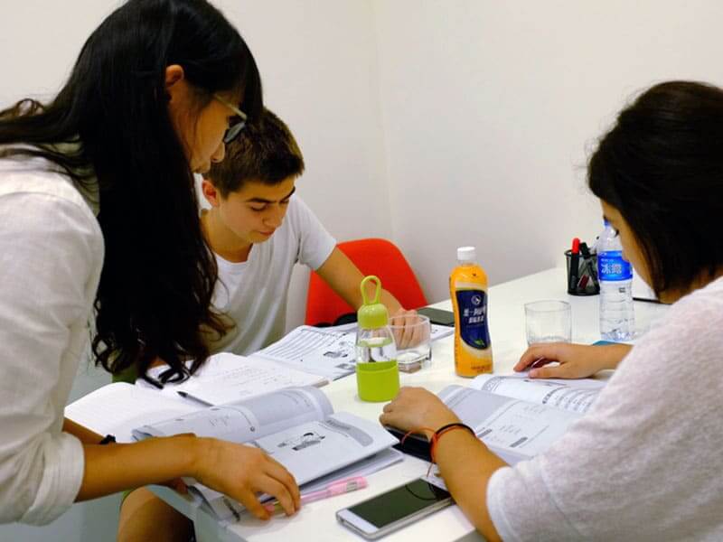 Teacher and two students having Chinese class in Shanghai