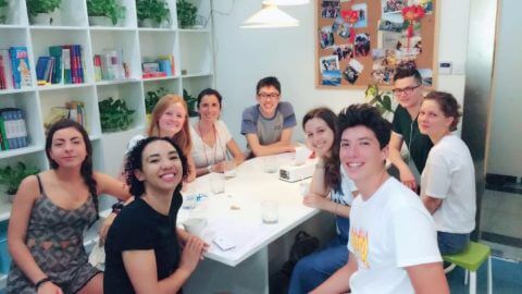 Students sitting around a table at LTL Shanghai for the welcome breakfast 